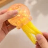 S055e2aef806348168f4ae2c475e6107d0.webp Transparent Jellyfish Sequin Squishy Toy – Soft Stretchable Sensory Stress Relief Plush