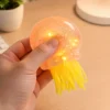 S960fae3cc8254e159f70a9e78c717579H.webp Transparent Jellyfish Sequin Squishy Toy – Soft Stretchable Sensory Stress Relief Plush